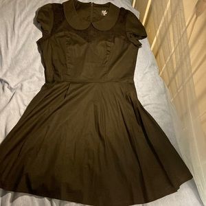 Retro style black cocktail dress with skulls and cutaway